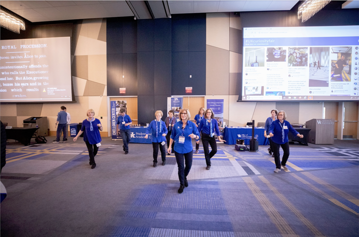 Group of staff members performing in ballroom