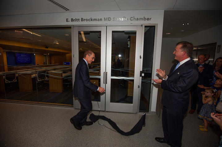 photo of UK President Eli Capilouto and Board Chair Britt Brockman after unveiling of name over Senate Chamber door.