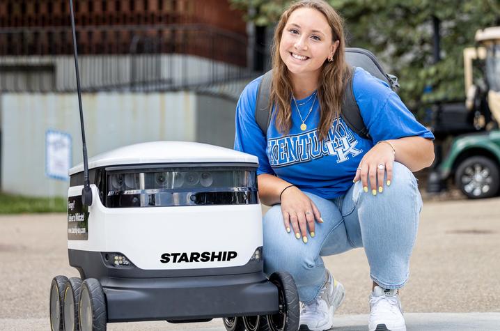 photo of student next to Starship robot