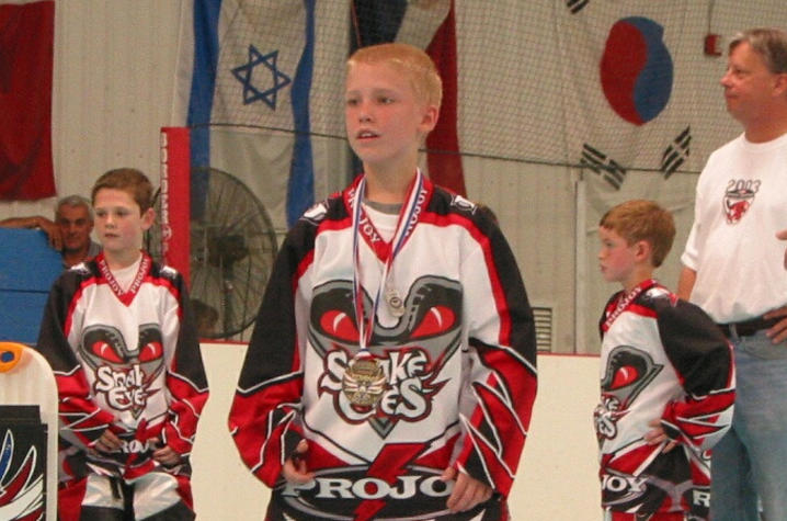 Adam Stickney on the ice with gold medal, 2003. 
