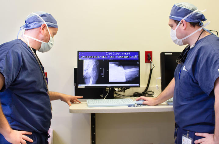 Matuszewski and Stringer view an x-ray for a patient with a hip fracture