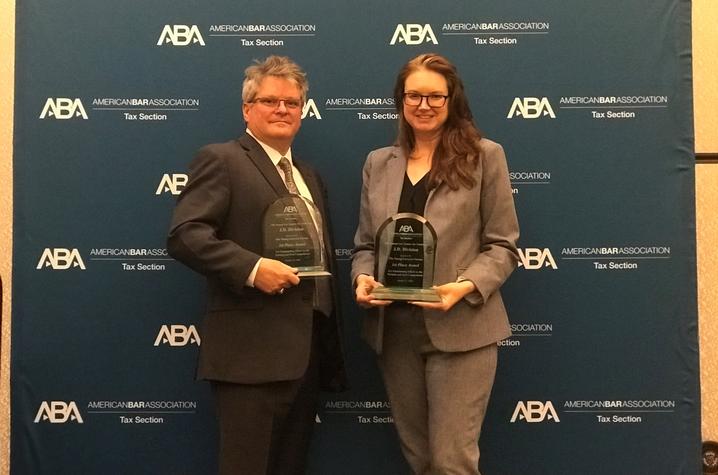 Law students Amanda Krugler and Scott Sullivan pose with awards