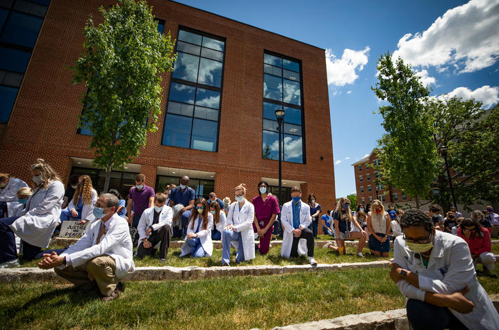 Dr. Larry Goldstein (left) and Dr. Ima Ebong (right) kneel at the Time for Justice event in the courtyard of Jacobs Science Building. Photo by Pete Comparoni | UKphoto