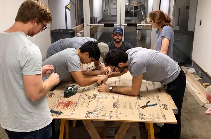 photo of UK College of Design students working on LED installation