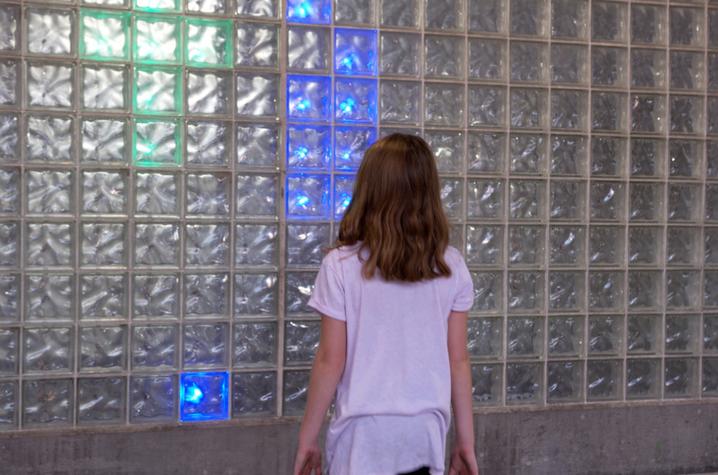 photo of child interacting with LED installation created by UK College of Design