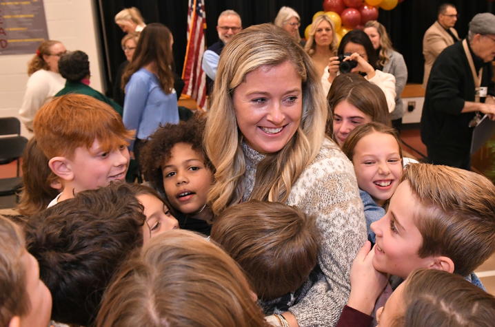 Jenna Stewart receiving a group hug from her class. 