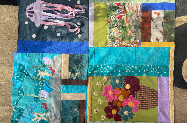 UK Climate Quilt A four-panel quilt with designs including a jellyfish, floral patterns, and ocean-themed fabric.