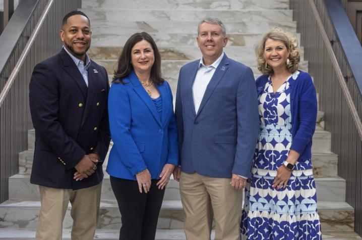 photo of UKAA 2026-27 officers Four people pose on a marble staircase inside a campus building.