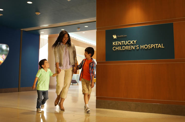 Photo of mother and young children walking out Kentucky Children's Hospital