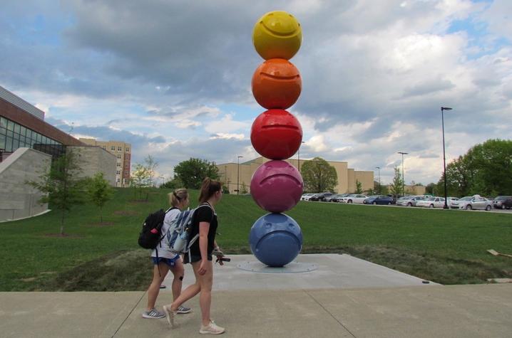 photo of 2 students passing by "Mood Sculpture" by Tony Tasset