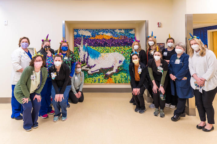image of group of healthcare workers around unicorn mosaic