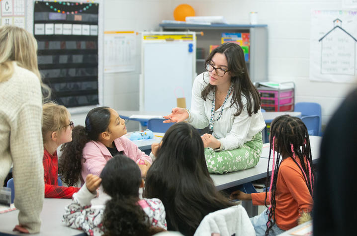 A teacher speaking to a room of students.