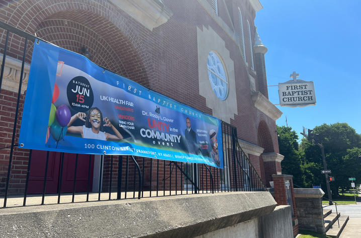 Unity in the Community event poster hung on railing of First Baptist Church Frankfort