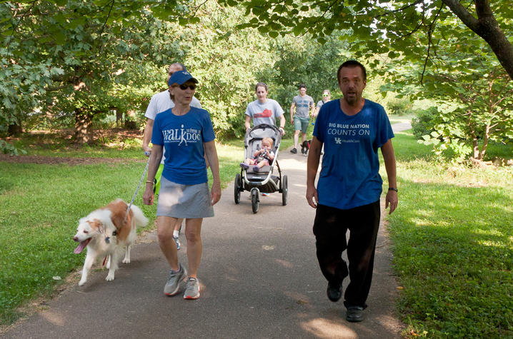 image of group of people walking on a path outside