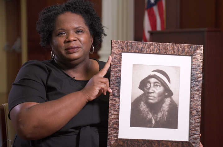 photo of Melynda Price holding black and white photo of her 