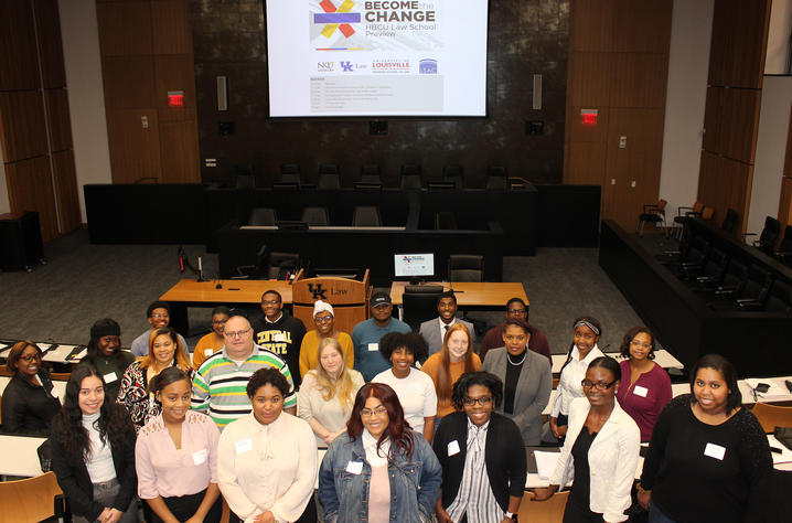 30 students pose in the courtroom