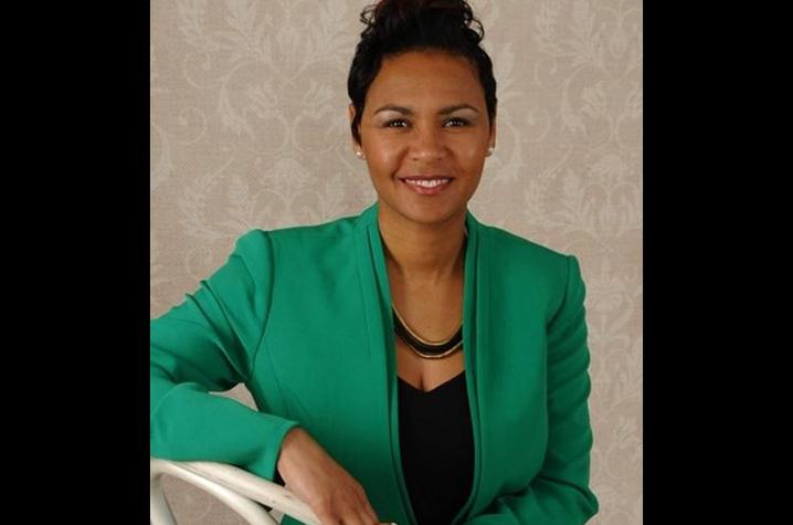 Catrena Bowman-Thomas pictured wearing green blazer against taupe background