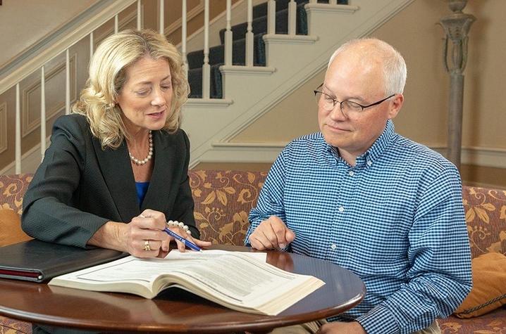 Caroline Francis and a gentleman review a publication in UK Alumni Career Services. Photo by Hal Morris.