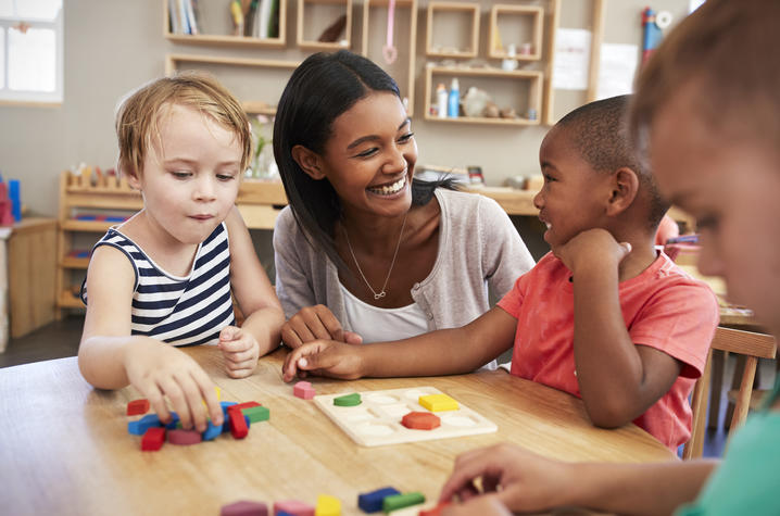 photo of teacher talking to children in child care setting