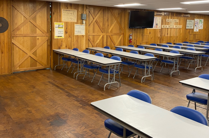 Image of classroom with tables and blue chairs