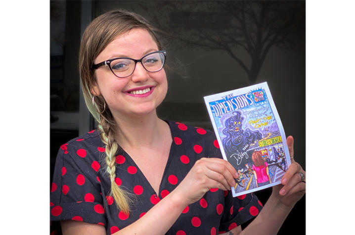 artist holding comic book