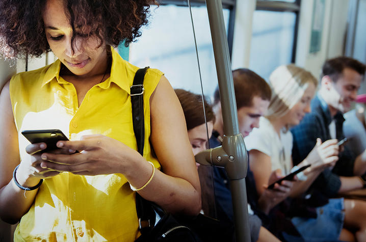 Girl on the bus texting. 