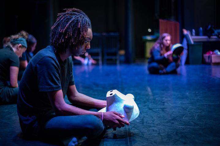 photo of GSA drama students, young man in forefront with mask 