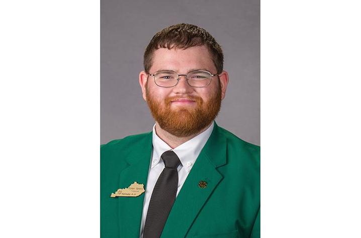 Headshot of UK senior Dylan Gentry pictured in green jacket with black tie