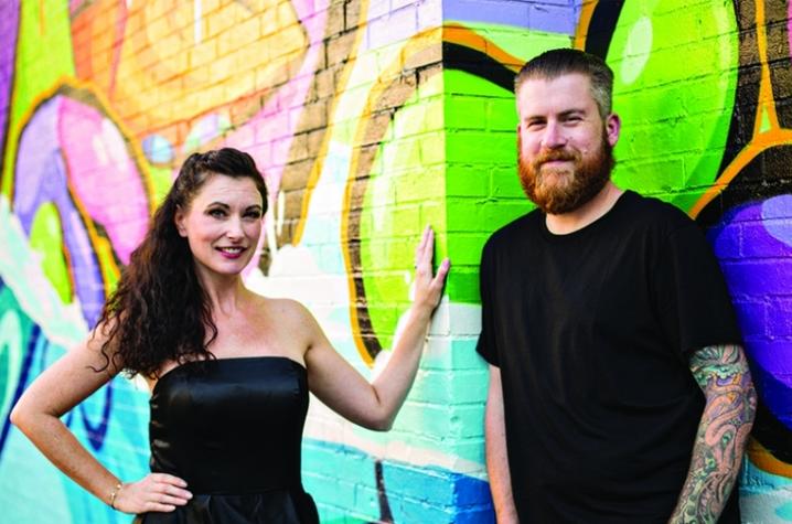 photo of Jessica and John Winters by PRHBTN mural