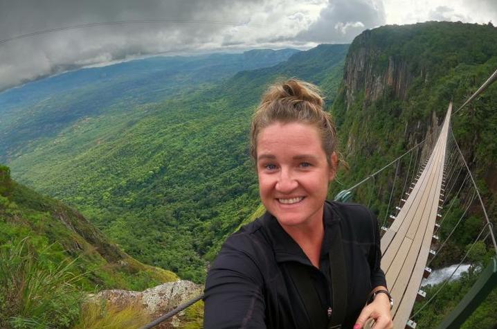 Sarah Marshall smiles on bridge overlooking landscape