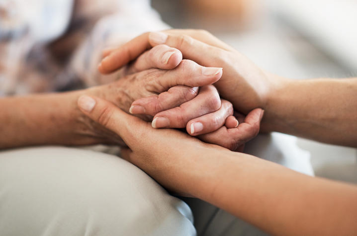 Two people holding hands. 