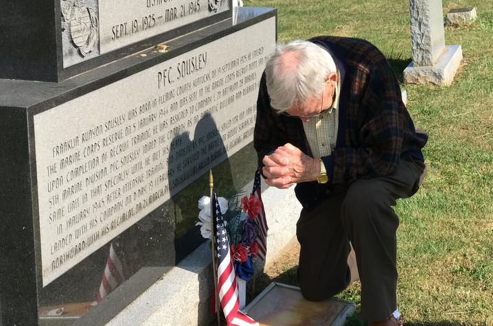 photo of Elwood Woody Hughes kneeling at Sousley gravesite