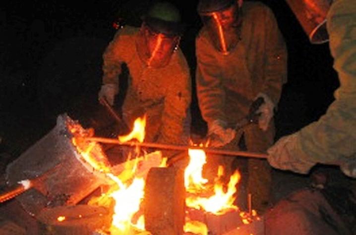 artists working at Iron Pour at dark