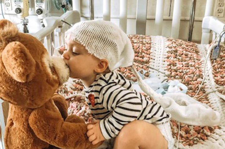 photo of Jaidyn with teddy bear in hospital bed