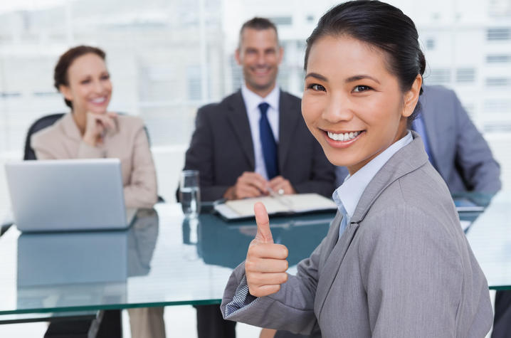 stock photo of job candidate at interview giving thumbs up
