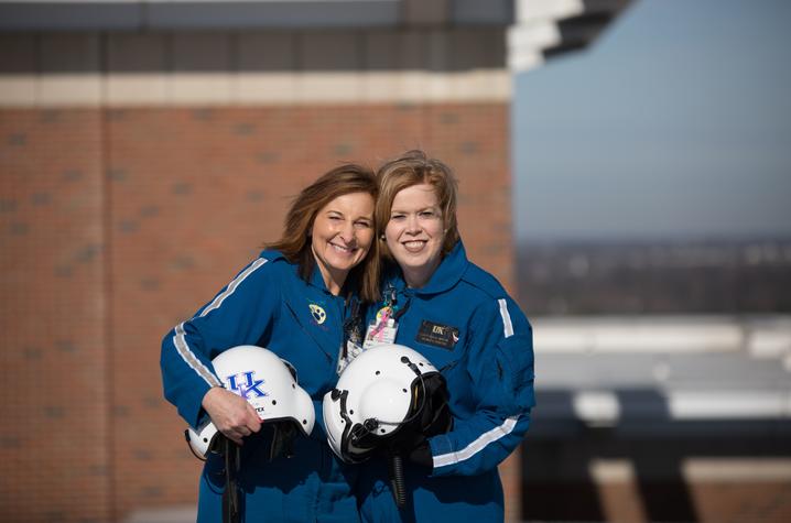 Deb Rice (left) and Caty Curlis standing on the helipad smiling