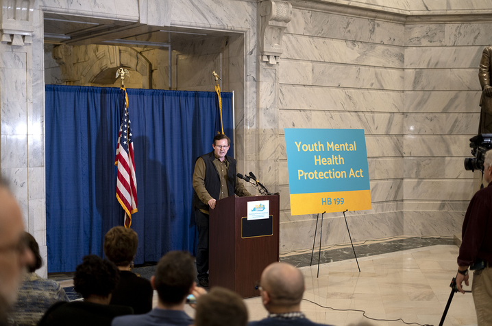 Michael Frazier speaking at podium