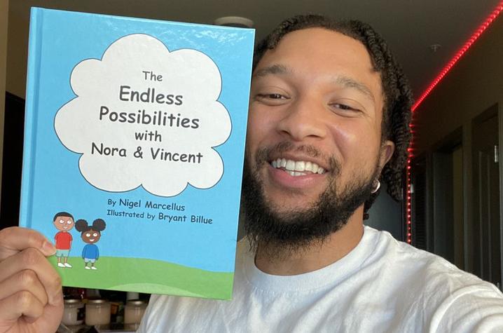 Nigel Taylor holding "The Endless Possibilities with Nora and Vincent.” 