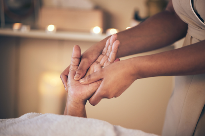 Closeup of woman massaging hand for stress relief, comfort or zen in healing.