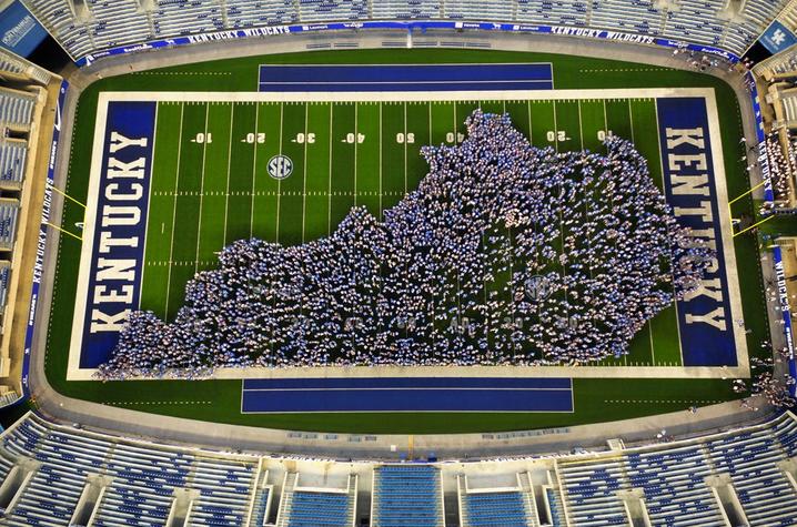 students making the shape of Kentucky on the football field