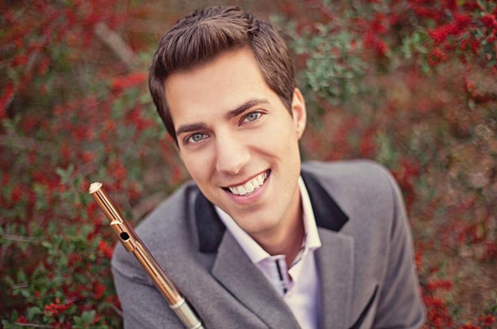 headshot photo of Seth Morris outside with flute