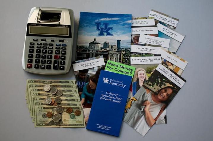 Image of calculator, dollar bills and pamphlets regarding scholarships and the College of Agriculture, Food and Environment