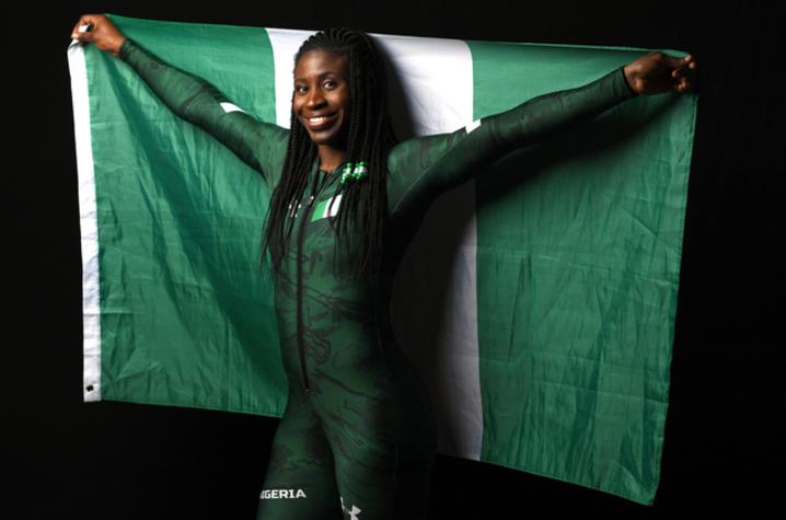The photo of Simidele "Simi" Adeagbo holding the Nigerian flag. 
