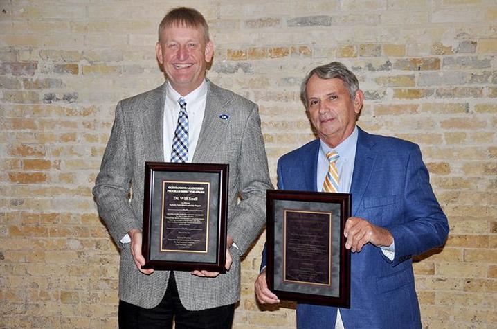 Image of Will Snell (left) and Steve Isaacs (right) holding awards
