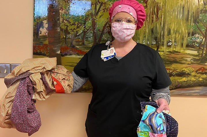 Healthcare worker holding donated surgical caps