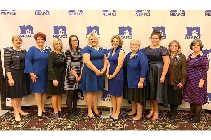 Portrait of UK Extension Agent representatives in formal attire with sponsored backdrop