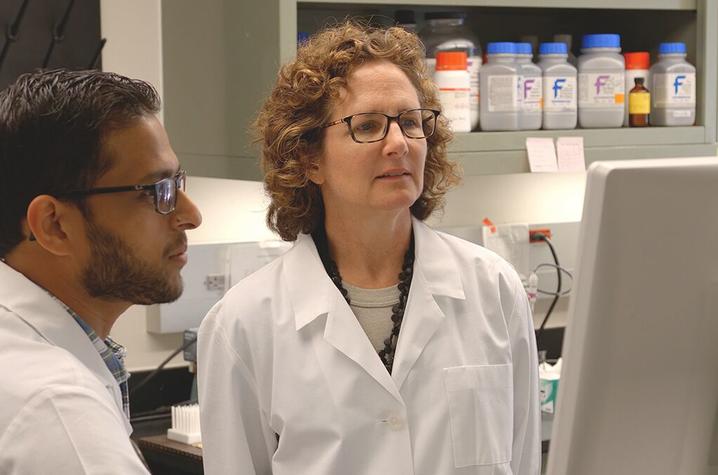 Madhur Agrawal, a postdoc in pharmacology & nutritional sciences, discusses findings with Barbara Nikolajczyk in her lab in the Wethington building.