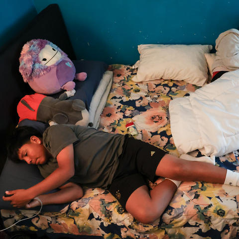 Adan Macias and his mother, Rosario Macias, rest in their bed on Sunday, June 1, 2025, in their home in Daly City, California. On Sundays, the two spend as much time together as possible, even if it's just resting in bed. Photo by Abbey Cutrer.
