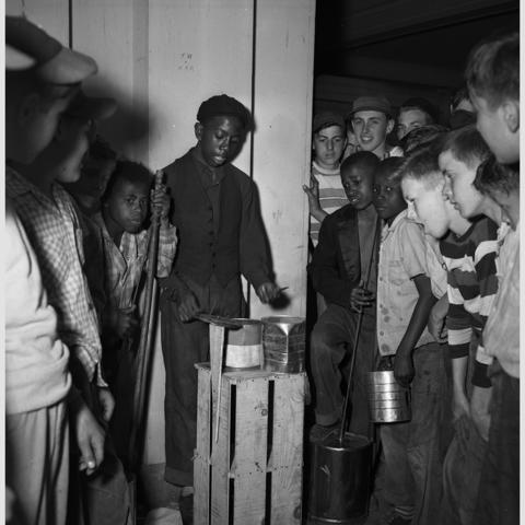 black and white photo of boys playing/watching jug band