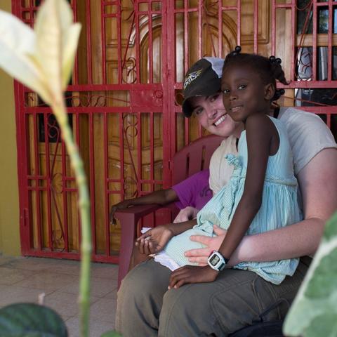 photo of UK student and child at Haiti orphanage
